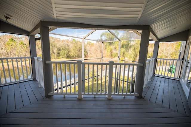 deck featuring a water view and glass enclosure