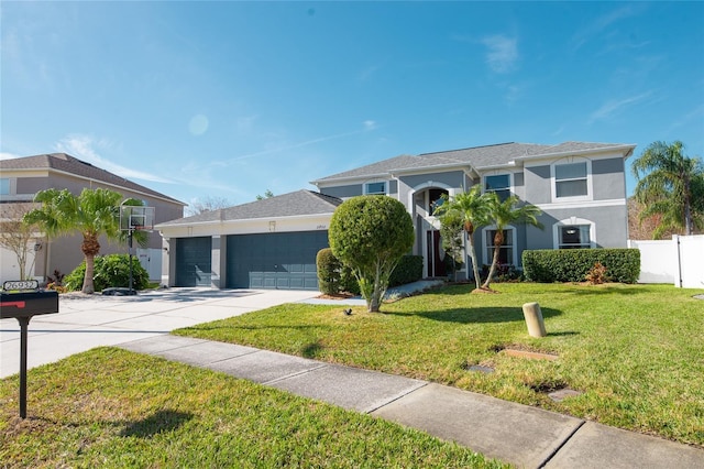 view of front of property with a garage and a front lawn