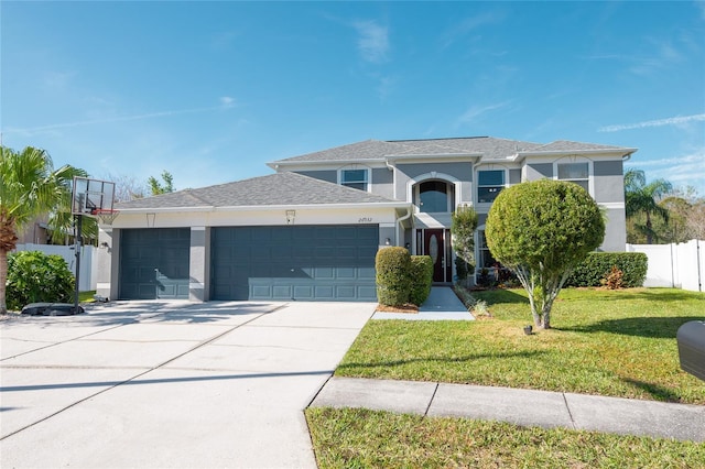 view of front of property featuring a garage and a front lawn