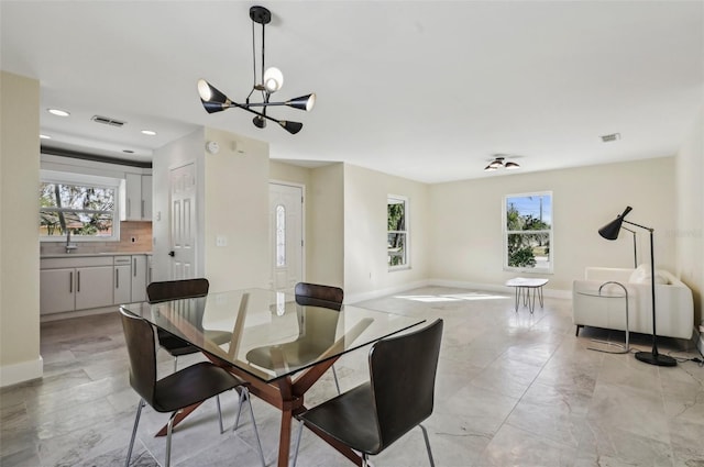 dining room with a notable chandelier and a wealth of natural light