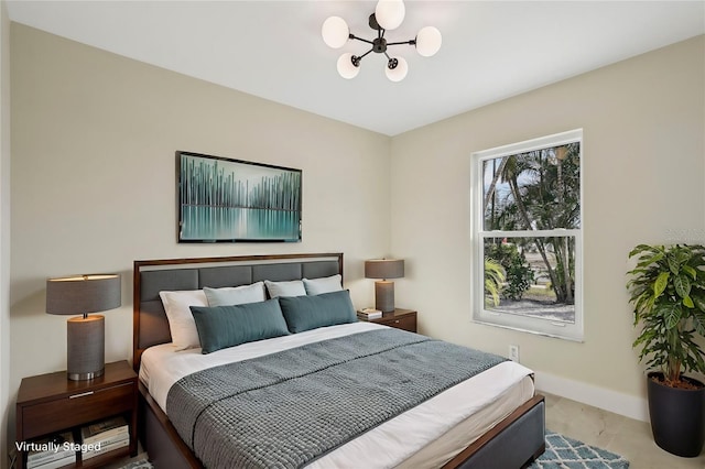 bedroom featuring a notable chandelier