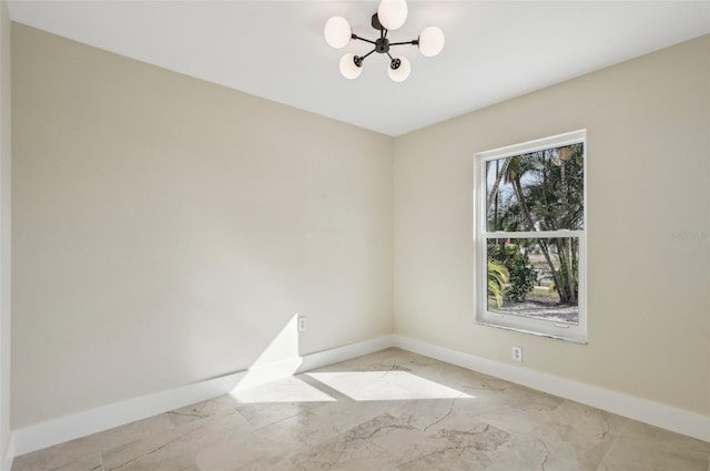 spare room with an inviting chandelier