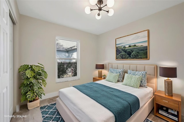 bedroom featuring an inviting chandelier and a closet