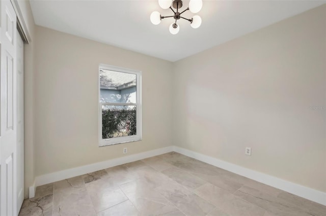 unfurnished room featuring a notable chandelier