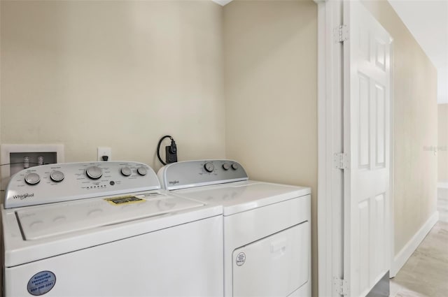 clothes washing area featuring independent washer and dryer