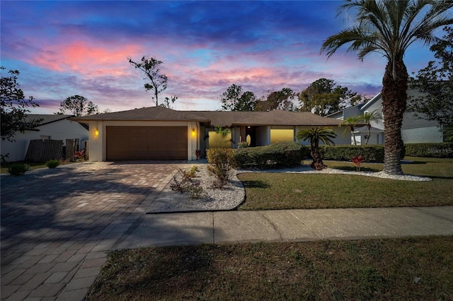 view of front facade featuring a garage and a lawn