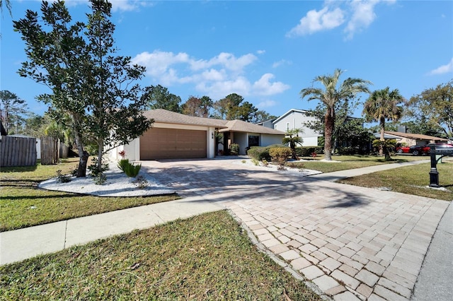 ranch-style home featuring a garage and a front yard