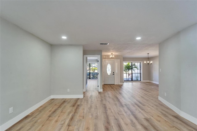 foyer featuring an inviting chandelier and light hardwood / wood-style floors