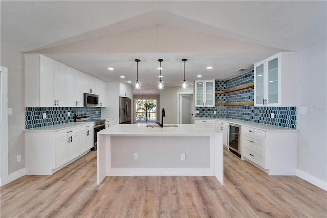 kitchen featuring wine cooler, lofted ceiling, stainless steel appliances, and sink