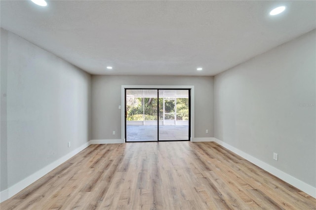 spare room featuring light wood-type flooring