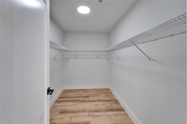 walk in closet featuring hardwood / wood-style floors