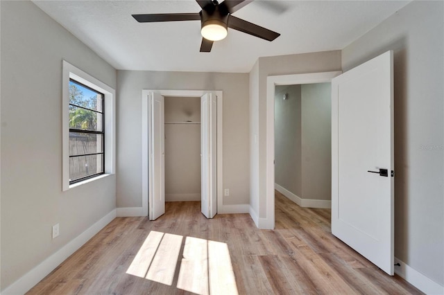 unfurnished bedroom with ceiling fan and light wood-type flooring