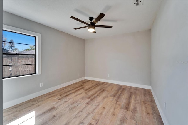 spare room with ceiling fan and light wood-type flooring