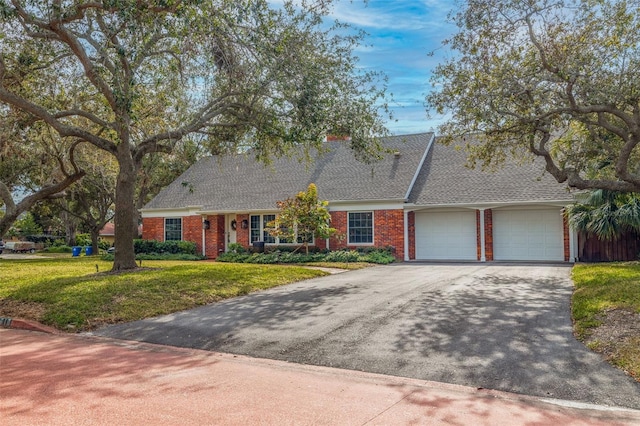 view of front of home with a garage and a front yard