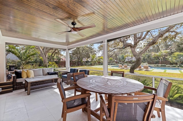 sunroom with wood ceiling and ceiling fan