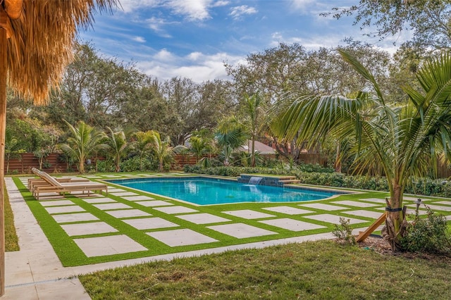 view of swimming pool with a lawn