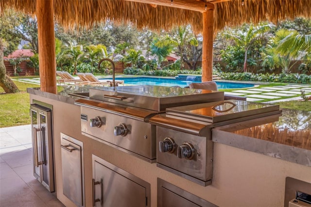 view of patio / terrace with area for grilling, wine cooler, and exterior kitchen