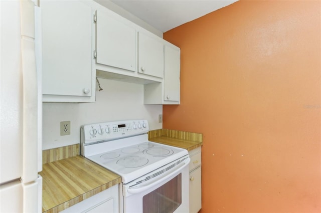 kitchen with white cabinetry and white appliances