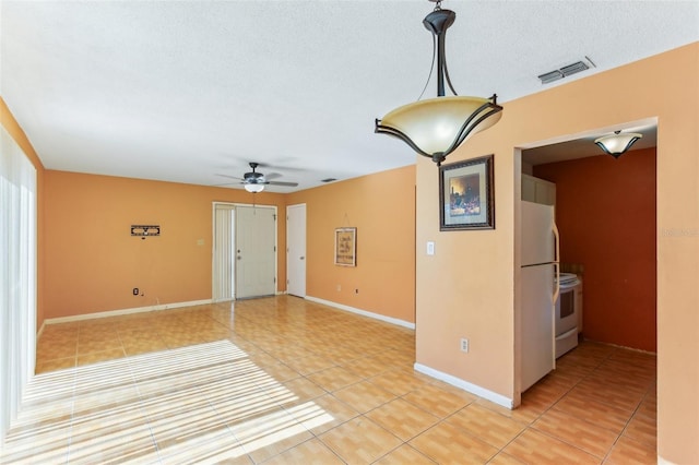 interior space featuring ceiling fan and a textured ceiling