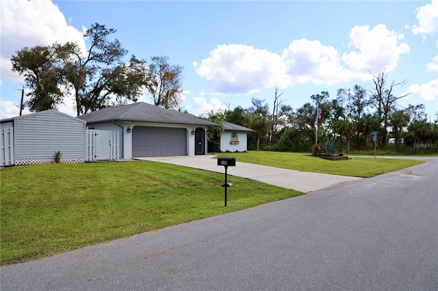 ranch-style house featuring a garage and a front lawn