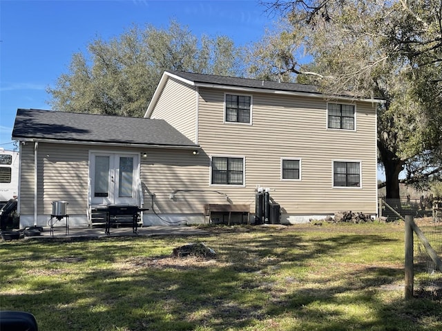 back of property with french doors, a yard, and a patio