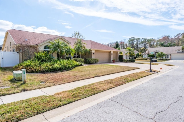 view of front of property with a garage and a front lawn