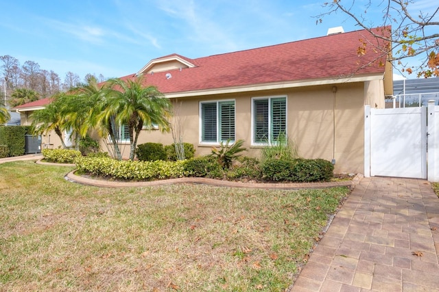 view of property exterior with a yard