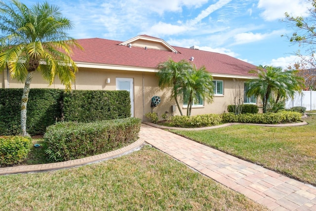 ranch-style home featuring a front yard