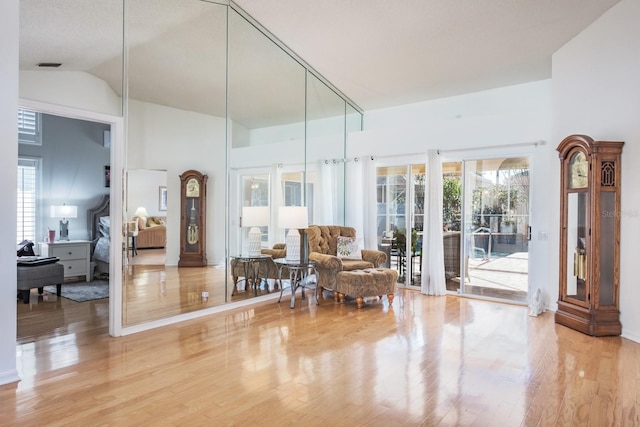 sitting room featuring lofted ceiling and hardwood / wood-style floors