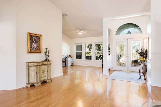 foyer entrance featuring french doors, ceiling fan, and light hardwood / wood-style flooring