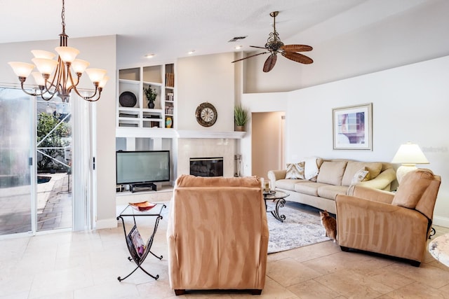 living room with ceiling fan with notable chandelier, vaulted ceiling, and built in features