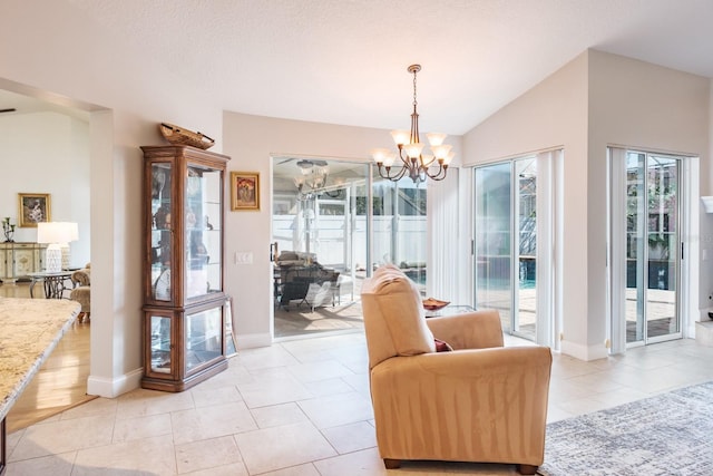 interior space featuring light tile patterned flooring, vaulted ceiling, a textured ceiling, and an inviting chandelier