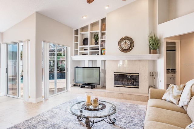 living room with high vaulted ceiling and a high end fireplace