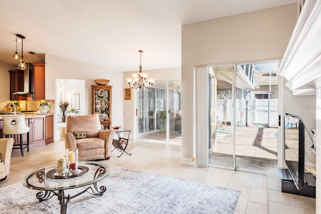 tiled living room featuring an inviting chandelier, lofted ceiling, and sink