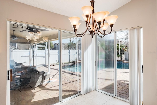 doorway with ceiling fan with notable chandelier, vaulted ceiling, and light tile patterned floors