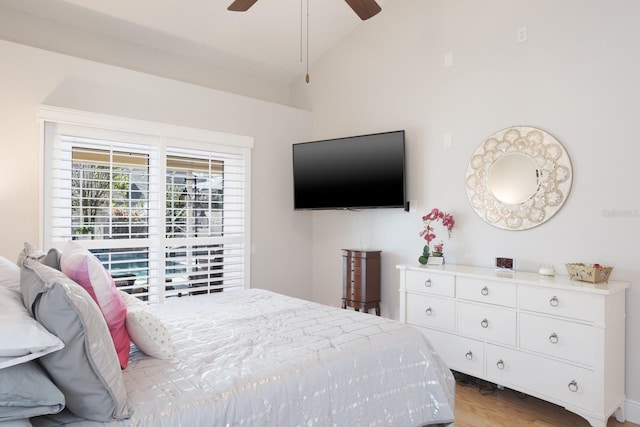 bedroom featuring ceiling fan, light hardwood / wood-style floors, and vaulted ceiling