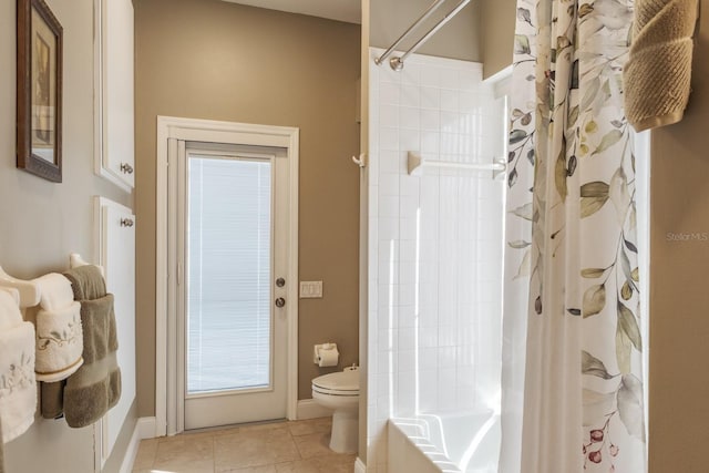 bathroom featuring tile patterned floors, toilet, and shower / bath combo with shower curtain