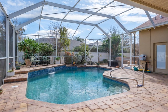 view of pool with pool water feature, a lanai, and a patio area