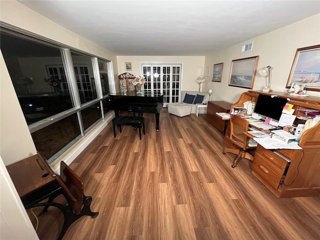 home office with visible vents and wood finished floors