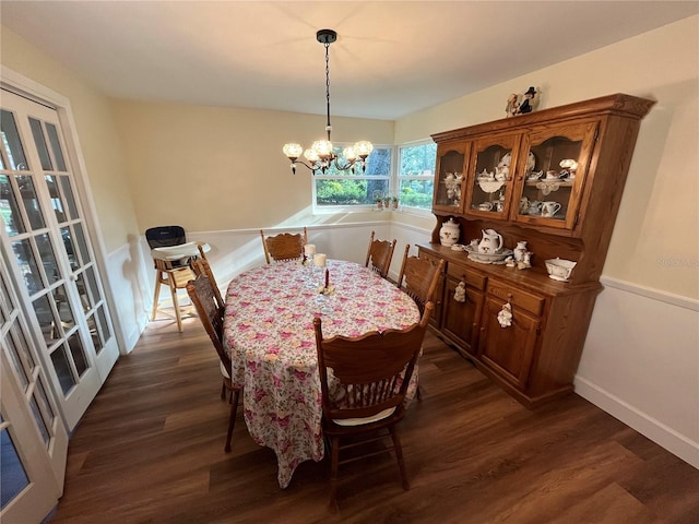 dining area with dark wood-style floors, baseboards, and an inviting chandelier