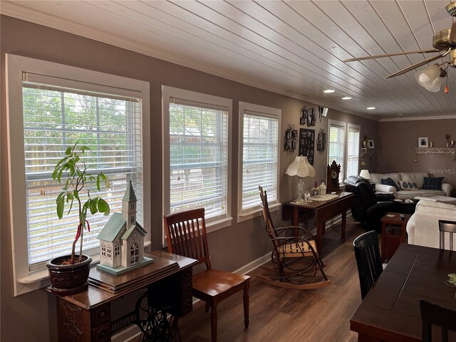 dining room featuring wooden ceiling, wood finished floors, a ceiling fan, baseboards, and ornamental molding