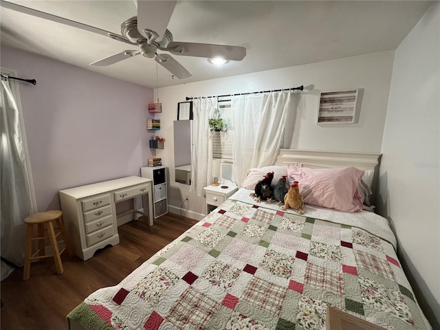 bedroom with ceiling fan, baseboards, and dark wood-type flooring