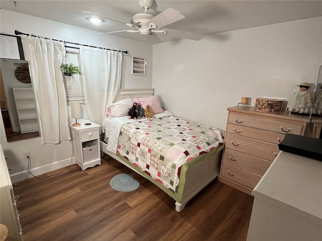 bedroom with ceiling fan and dark wood-style flooring