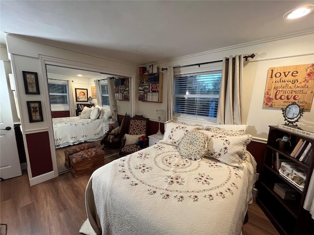 bedroom with baseboards and wood finished floors