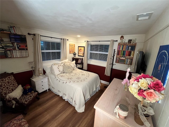 bedroom with dark wood finished floors