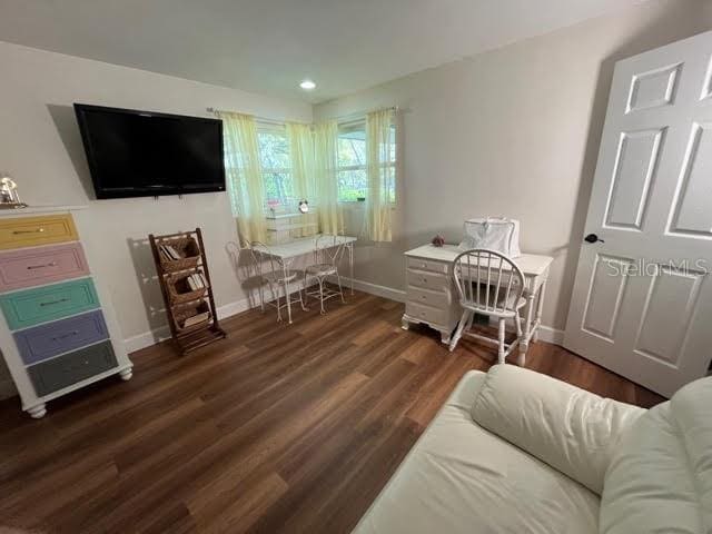 interior space with recessed lighting, wood finished floors, and baseboards