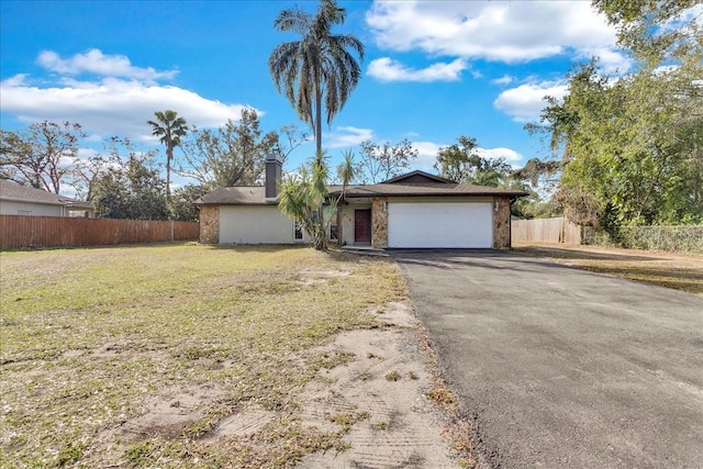 single story home with a garage and a front yard