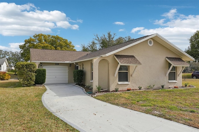 view of front facade with a garage and a front lawn