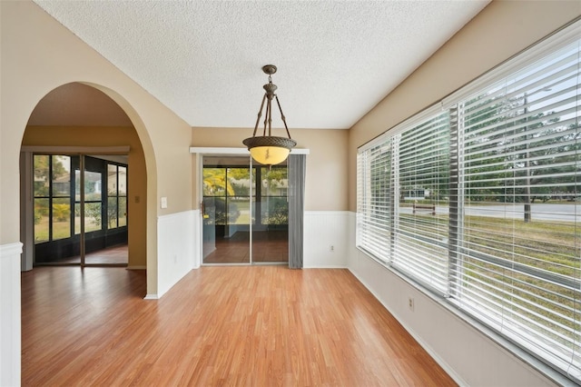 interior space with hardwood / wood-style flooring and a textured ceiling