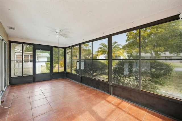 unfurnished sunroom with ceiling fan